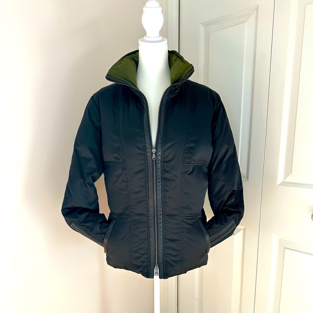 Fabrizio Lenzi zip-up puffer jacket, green lining, and black leather accents.